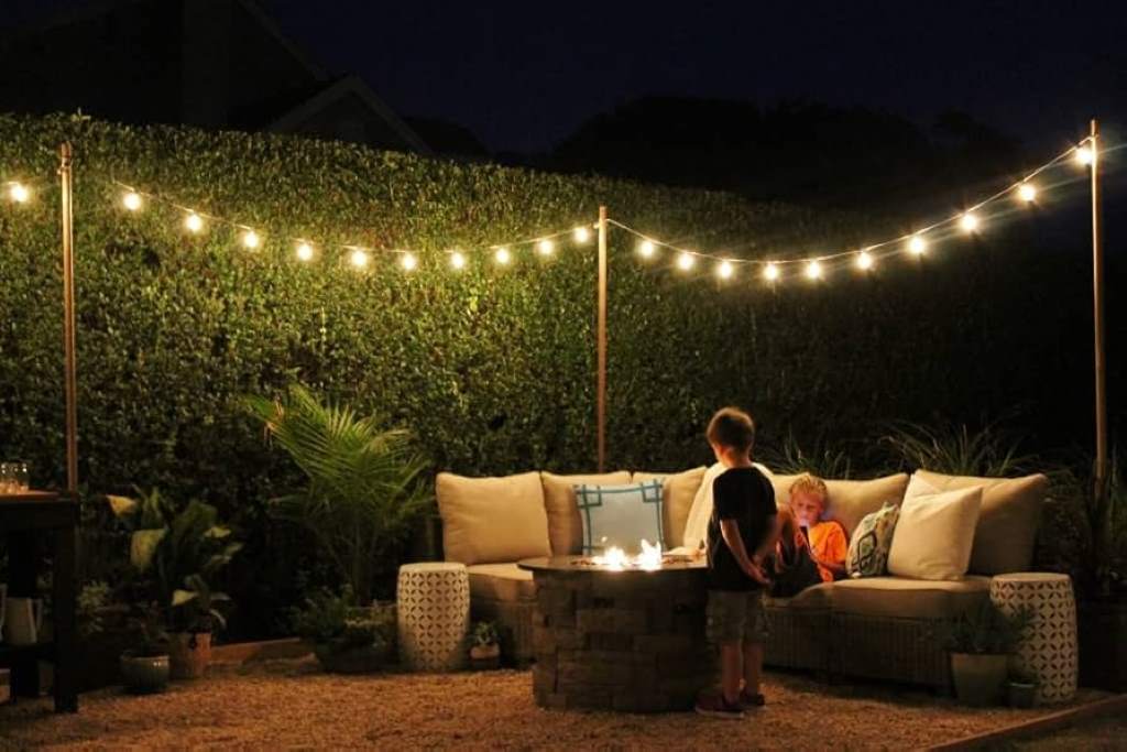 remote control LED rope lights glowing in multiple colors against a backyard patio at dusk