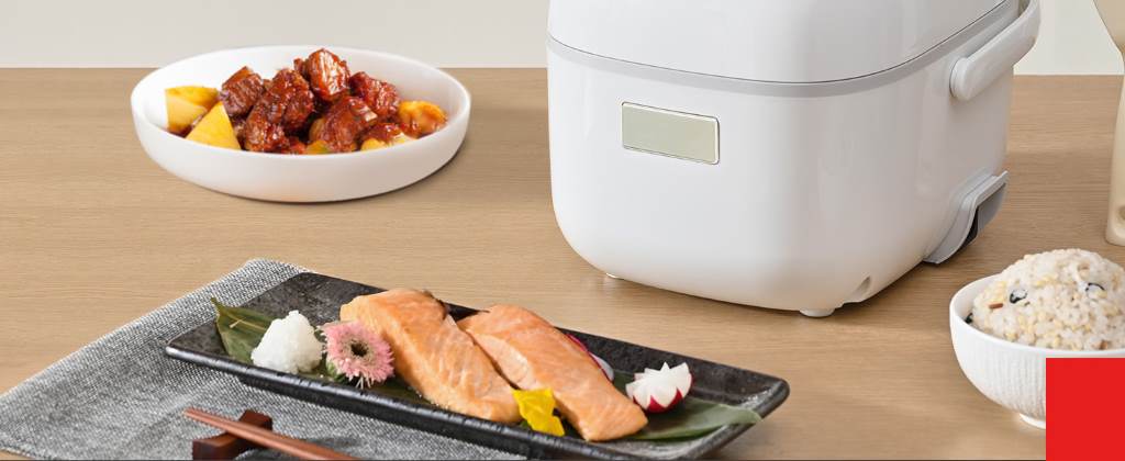 Toshiba 3-cup mini rice cooker with fluffy white rice in bowl on kitchen table